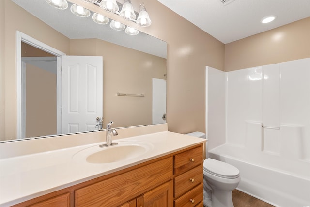 bathroom featuring vanity, toilet, and bathtub / shower combination