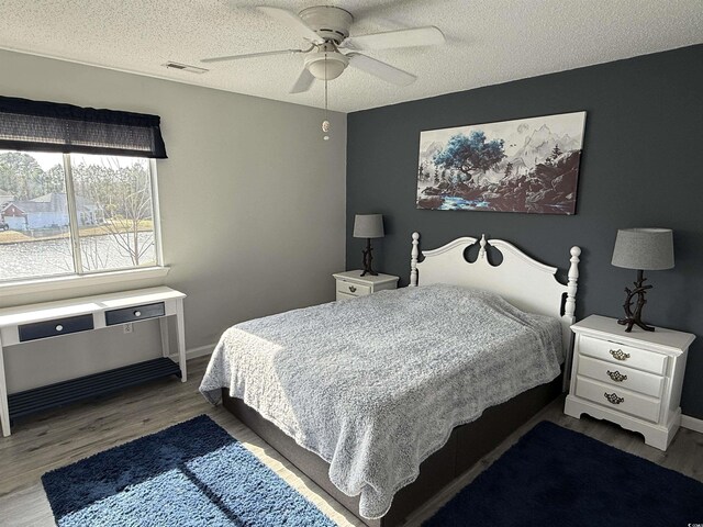 380-K Myrtle Greens Dr Unit 380-K, Conway, SC 29526 - bedroom with a textured ceiling, wood finished floors, baseboards, and a ceiling fan