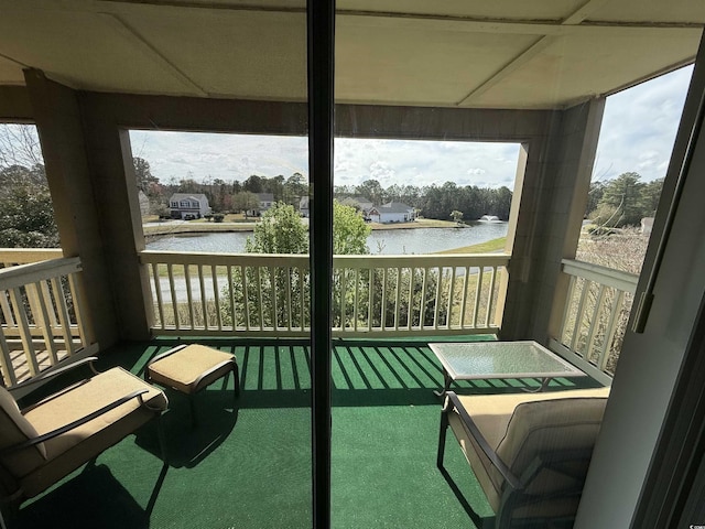 sunroom / solarium featuring a water view