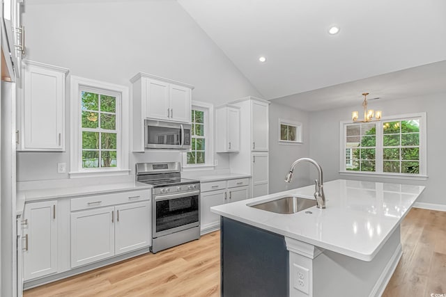 19 Coventry Pl, Pawleys Island, SC 29585 - kitchen with appliances with stainless steel finishes, a sink, a chandelier, light countertops, and high vaulted ceiling