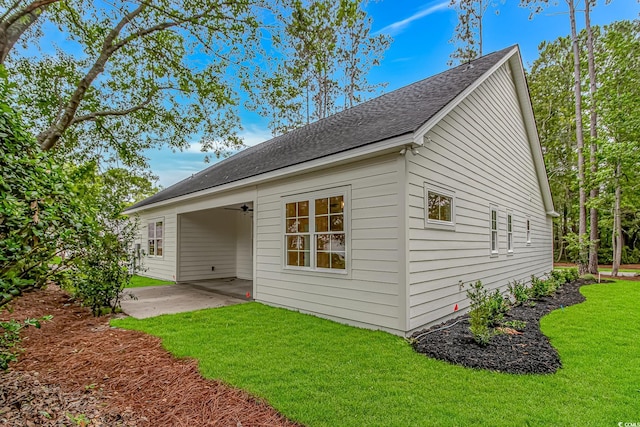 19 Coventry Pl, Pawleys Island, SC 29585 - back of property featuring a lawn, a patio area, roof with shingles, and a ceiling fan