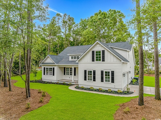 19 Coventry Pl, Pawleys Island, SC 29585 - modern farmhouse style home with board and batten siding, a front lawn, a shingled roof, a garage, and driveway