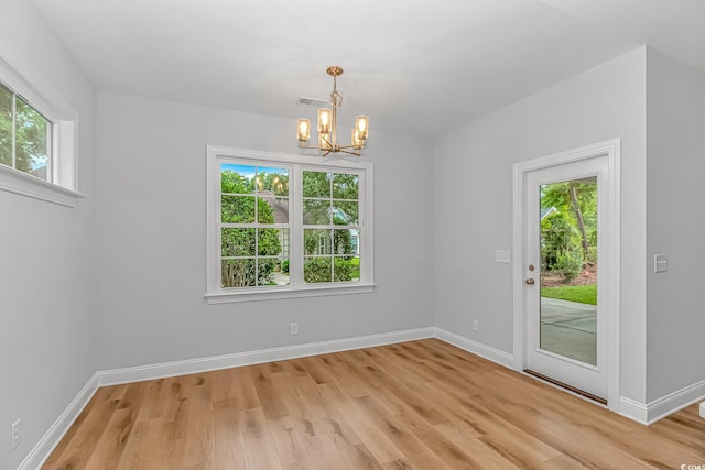 19 Coventry Pl, Pawleys Island, SC 29585 - unfurnished dining area with a chandelier, light wood-style floors, and baseboards