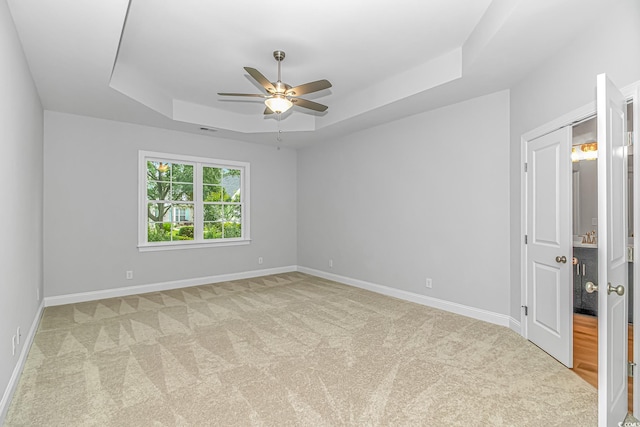 19 Coventry Pl, Pawleys Island, SC 29585 - unfurnished room featuring a tray ceiling, a ceiling fan, light carpet, and baseboards