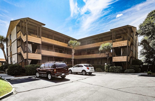 view of building exterior with uncovered parking