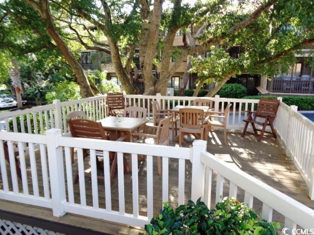 wooden deck featuring outdoor dining area