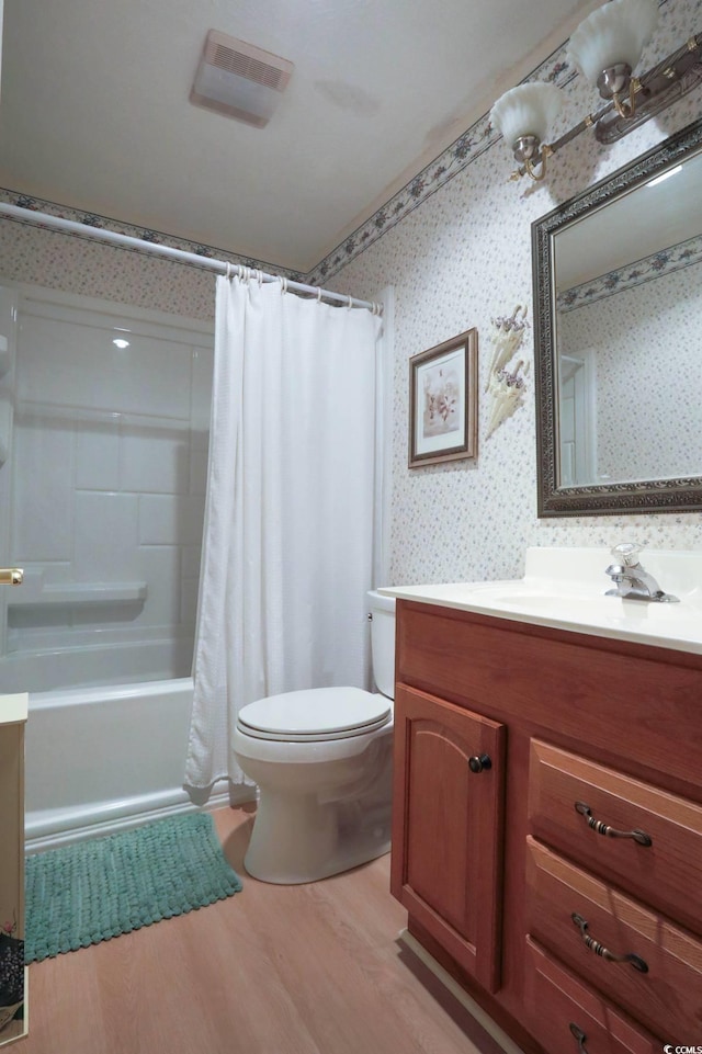 full bath with vanity, visible vents, wood finished floors, toilet, and wallpapered walls