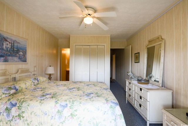 bedroom featuring a ceiling fan, dark carpet, and a closet