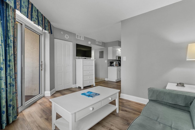 2801 S Ocean Blvd # 231, North Myrtle Beach, SC 29582 - living room with wood finished floors, visible vents, and baseboards