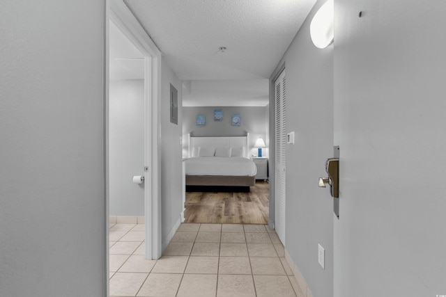 2801 S Ocean Blvd # 231, North Myrtle Beach, SC 29582 - hall with light tile patterned flooring, a textured ceiling, and baseboards