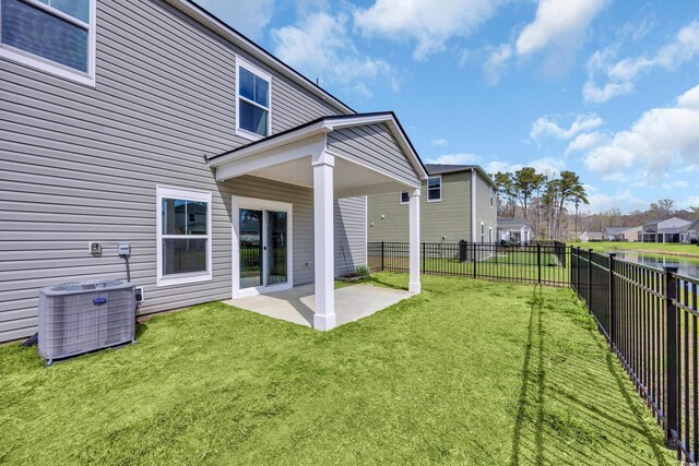 204 Leaflet Loop, Pawleys Island, SC 29585 - rear view of property featuring central AC, a patio area, and a residential view
