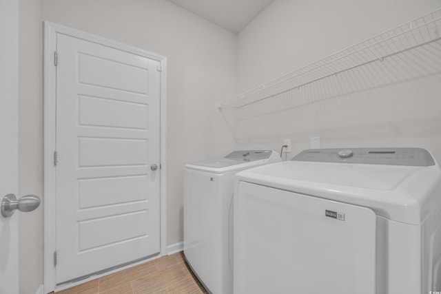 204 Leaflet Loop, Pawleys Island, SC 29585 - laundry room with washer and dryer, wood finish floors, and baseboards
