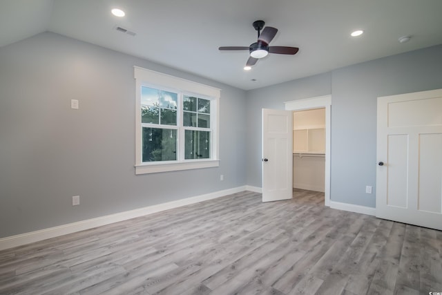224 Oak Bay Dr, Georgetown, SC 29440 - unfurnished bedroom with wood finished floors, baseboards, recessed lighting, a walk in closet, and ceiling fan
