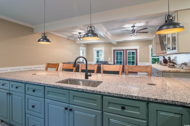 224 Oak Bay Dr, Georgetown, SC 29440 - kitchen with a sink, a ceiling fan, beamed ceiling, decorative light fixtures, and light stone countertops