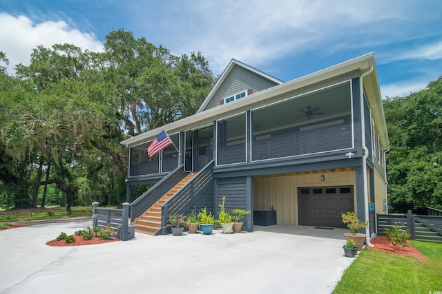 224 Oak Bay Dr, Georgetown, SC 29440 - view of front facade with driveway, a sunroom, a garage, fence, and stairs