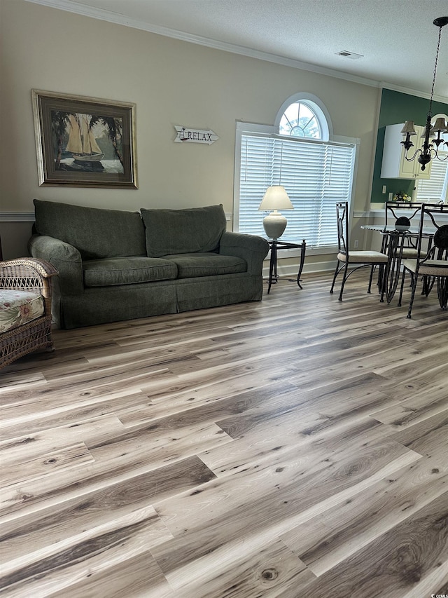 4639 Wild Iris Dr Unit 43-204, Myrtle Beach, SC 29577 - living area featuring crown molding, wood finished floors, and a chandelier