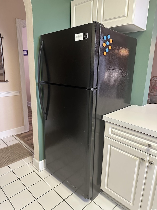4639 Wild Iris Dr Unit 43-204, Myrtle Beach, SC 29577 - kitchen featuring freestanding refrigerator, light tile patterned floors, light countertops, white cabinetry, and baseboards