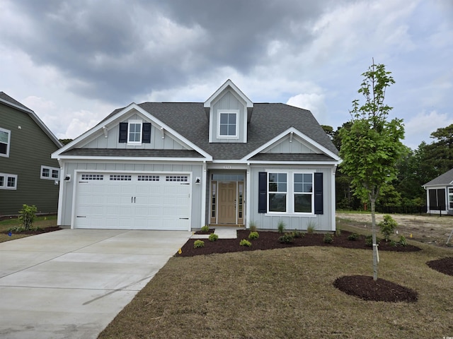 view of front of house featuring concrete driveway, a front lawn, board and batten siding, an attached garage, and roof with shingles