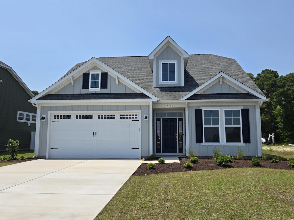 390 Starlit Way, Myrtle Beach, SC 29579 - view of front of property with board and batten siding, roof with shingles, a garage, driveway, and a front lawn