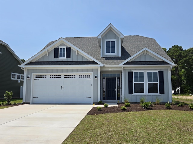 390 Starlit Way, Myrtle Beach, SC 29579 - view of front of property with board and batten siding, roof with shingles, a garage, driveway, and a front lawn