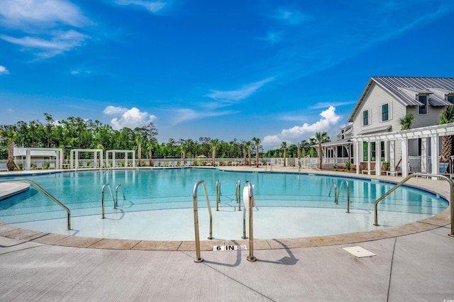 community pool featuring fence and a pergola