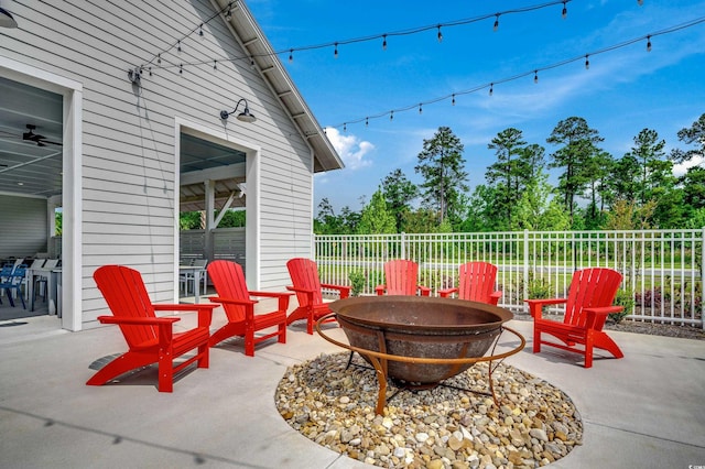 view of patio featuring a fire pit and fence