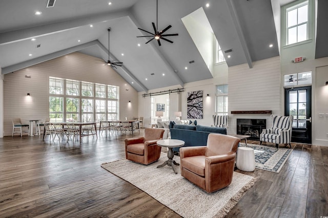living room with high vaulted ceiling, a ceiling fan, plenty of natural light, and wood finished floors