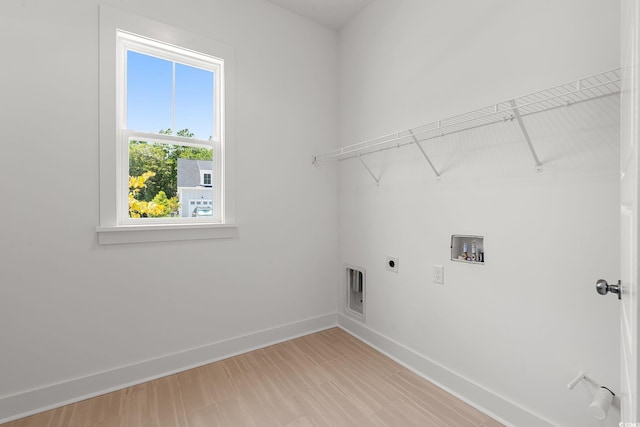 laundry area with hookup for a washing machine, hookup for an electric dryer, and baseboards