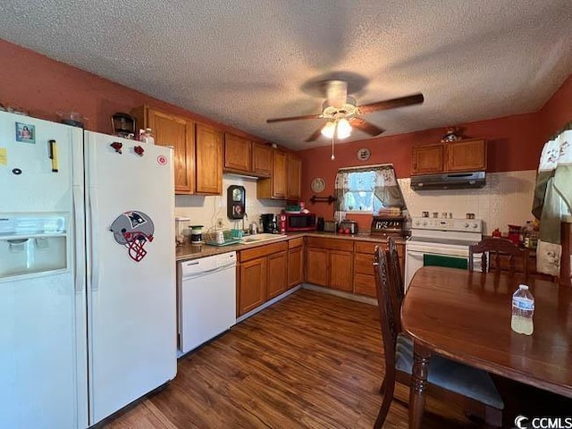 3641 Half Pint Rd, Longs, SC 29568 - kitchen featuring white appliances, under cabinet range hood, brown cabinets, ceiling fan, and a textured ceiling