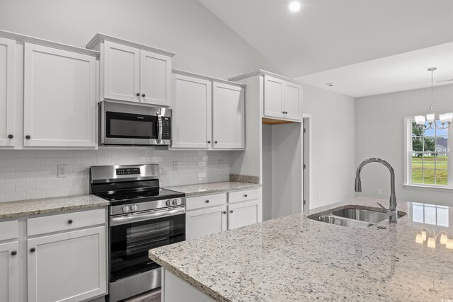 72 Millsite Ct, Georgetown, SC 29440 - kitchen with stainless steel appliances, a sink, white cabinets, tasteful backsplash, and lofted ceiling
