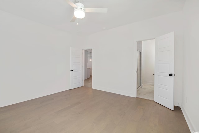 unfurnished bedroom featuring light wood finished floors, baseboards, and a ceiling fan