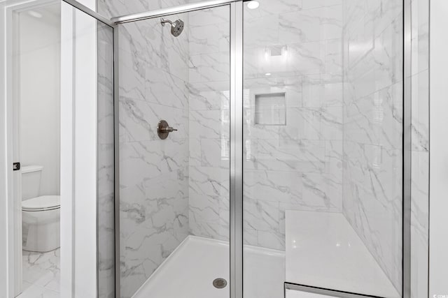 full bathroom featuring a stall shower and toilet