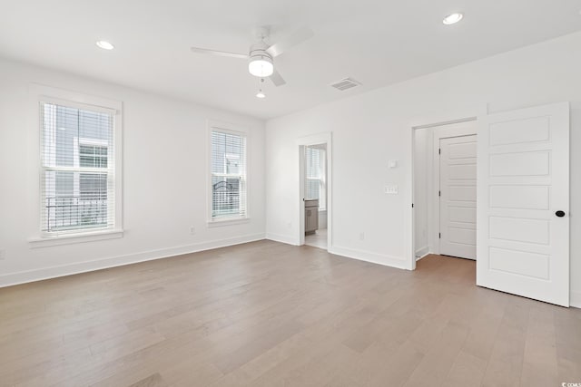 unfurnished bedroom featuring light wood-type flooring, baseboards, recessed lighting, ensuite bathroom, and ceiling fan