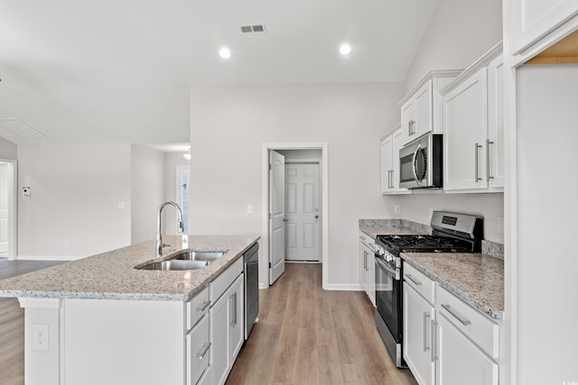 235 Six Mile Creek Dr, Georgetown, SC 29440 - kitchen featuring visible vents, light wood finished floors, a center island with sink, appliances with stainless steel finishes, and a sink