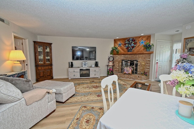 4242 Pinehurst Cir Unit N4, Little River, SC 29566 - living area featuring wood finished floors, a fireplace, a textured ceiling, and recessed lighting