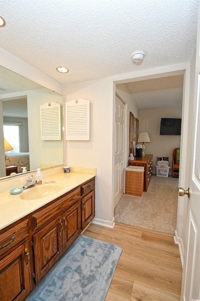 4242 Pinehurst Cir Unit N4, Little River, SC 29566 - ensuite bathroom with vanity, a textured ceiling, wood finished floors, and recessed lighting