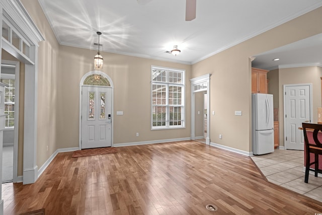 192 Berkshire Loop, Pawleys Island, SC 29585 - foyer entrance with light wood-style floors, ornamental molding, a ceiling fan, and baseboards