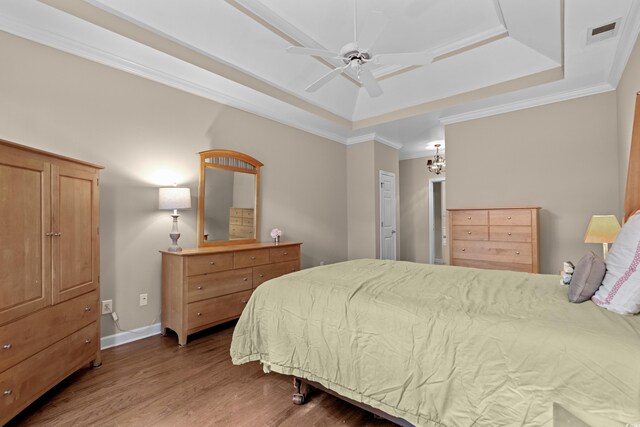 192 Berkshire Loop, Pawleys Island, SC 29585 - bedroom featuring a tray ceiling, wood finished floors, ornamental molding, a chandelier, and baseboards