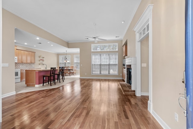192 Berkshire Loop, Pawleys Island, SC 29585 - living area with ornamental molding, light wood-style floors, a fireplace, a ceiling fan, and recessed lighting