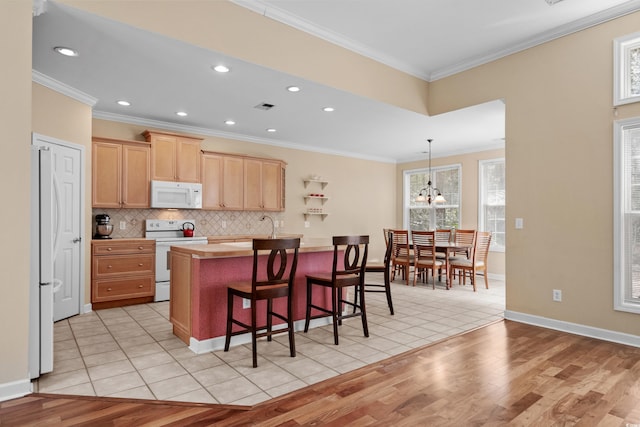 192 Berkshire Loop, Pawleys Island, SC 29585 - kitchen featuring white appliances, light brown cabinetry, light wood-type flooring, light countertops, and backsplash