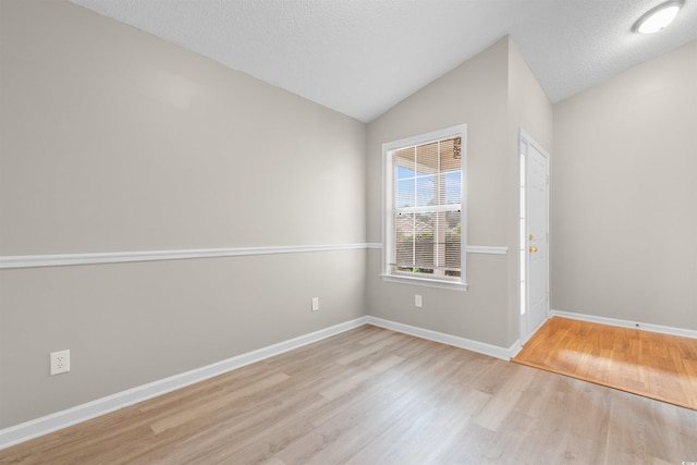 1202 Formby Ct, Myrtle Beach, SC 29588 - unfurnished room featuring a textured ceiling, wood finished floors, vaulted ceiling, and baseboards