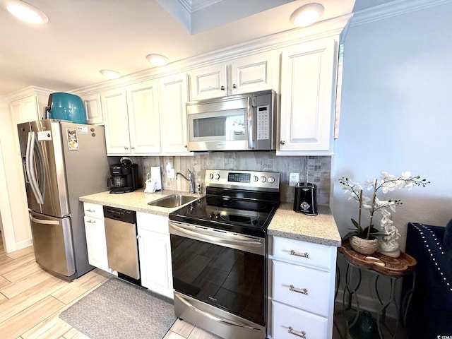 2001 S Ocean Blvd Unit 621, Myrtle Beach, SC 29577 - kitchen featuring backsplash, appliances with stainless steel finishes, light wood-type flooring, a sink, and white cabinets