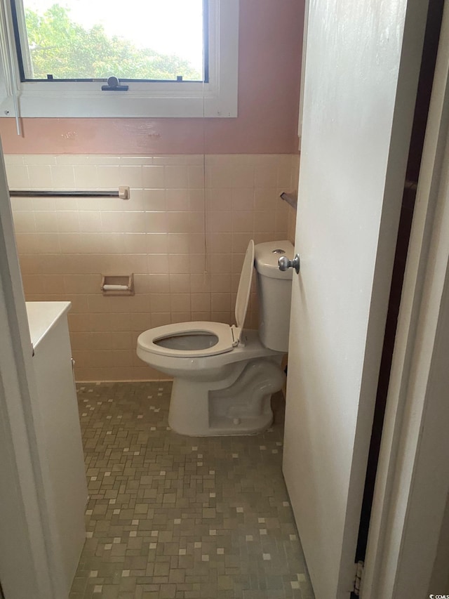 3752 Tea Rose St Unit 3752, Myrtle Beach, SC 29577 - bathroom featuring tile walls, toilet, plenty of natural light, a wainscoted wall, and tile patterned floors
