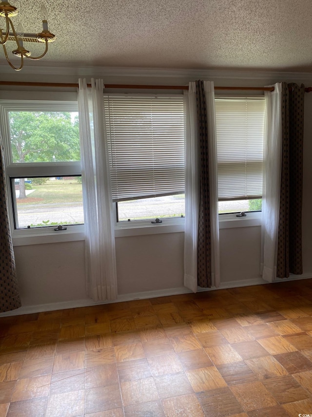 3752 Tea Rose St Unit 3752, Myrtle Beach, SC 29577 - empty room with a textured ceiling, plenty of natural light, a chandelier, and baseboards