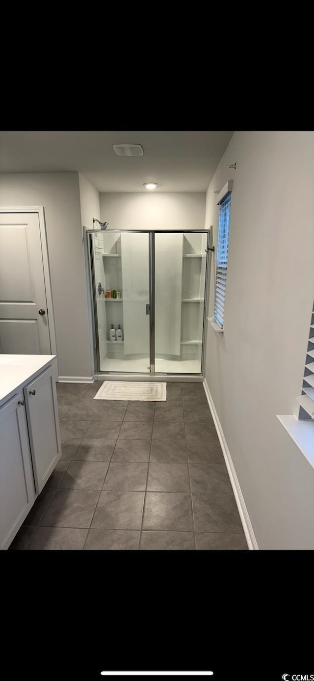645 Black Pearl Way, Myrtle Beach, SC 29588 - bathroom featuring an enclosed shower, baseboards, vanity, and tile patterned floors