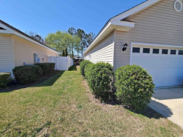 view of property exterior featuring an attached garage and driveway