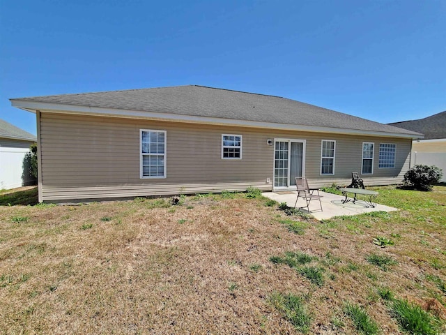 back of house featuring a patio and a lawn