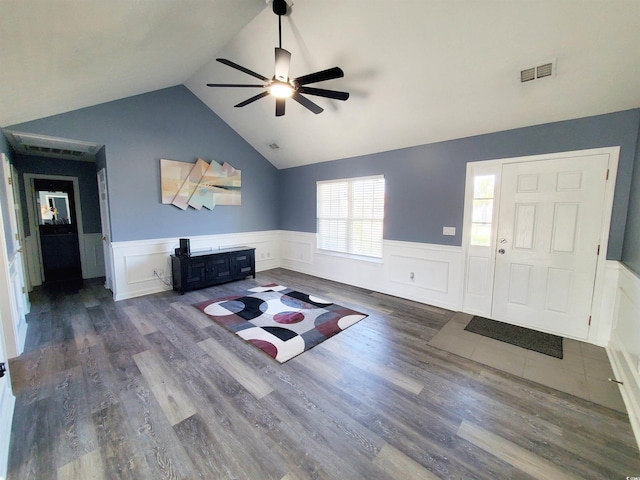 living room featuring a ceiling fan, a wainscoted wall, lofted ceiling, and wood finished floors