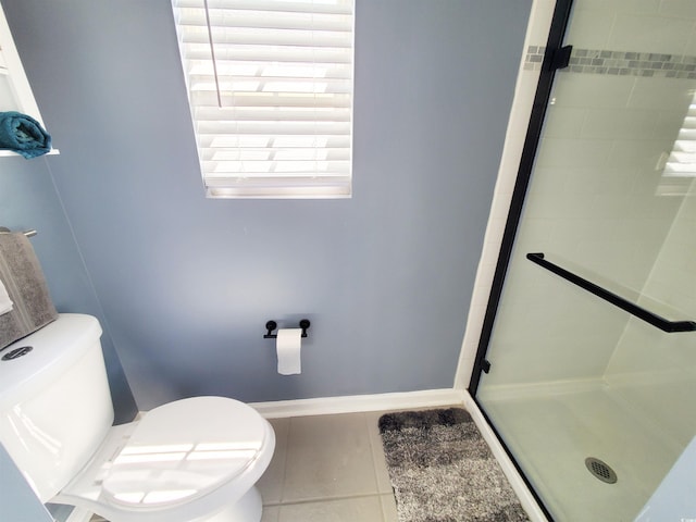 full bathroom with tile patterned floors, a shower stall, toilet, and baseboards