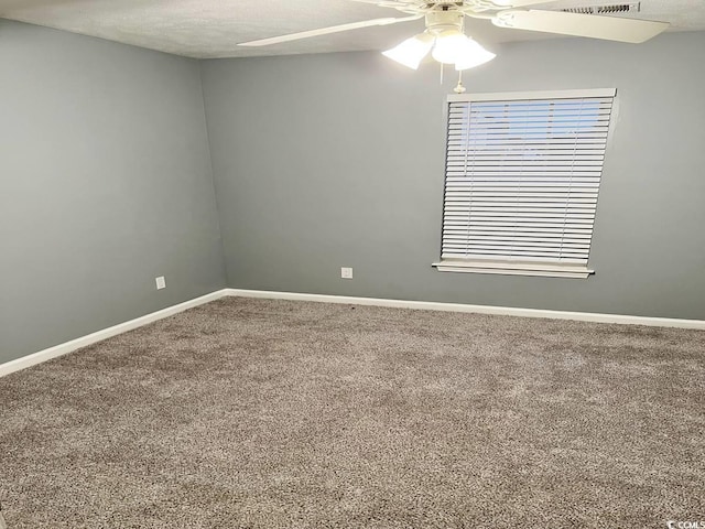 unfurnished room with carpet, a ceiling fan, and baseboards